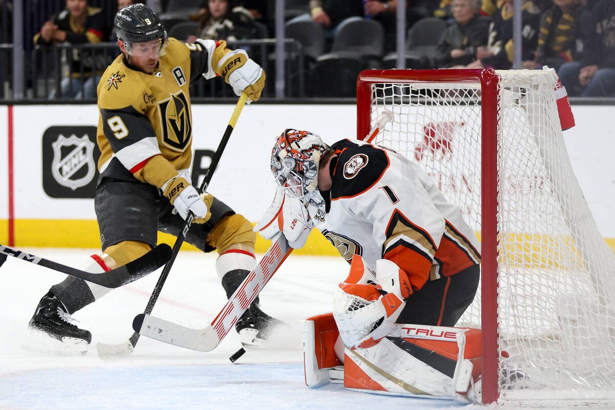 Ducks goaltender Lukas Dostal (1) saves the puck against Golden Knights center Jack Eichel (9) ...