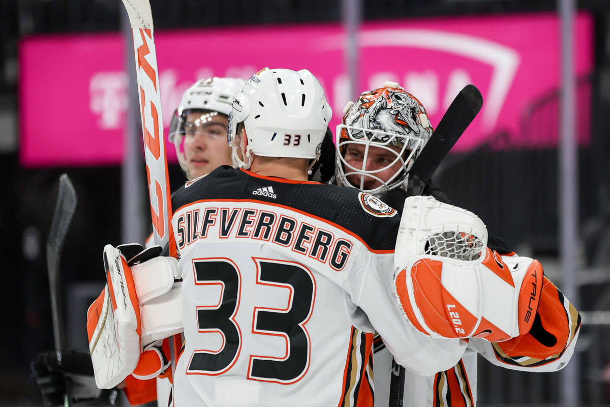 Ducks right wing Jakob Silfverberg (33) embraces Ducks goaltender Lukas Dostal after they won a ...
