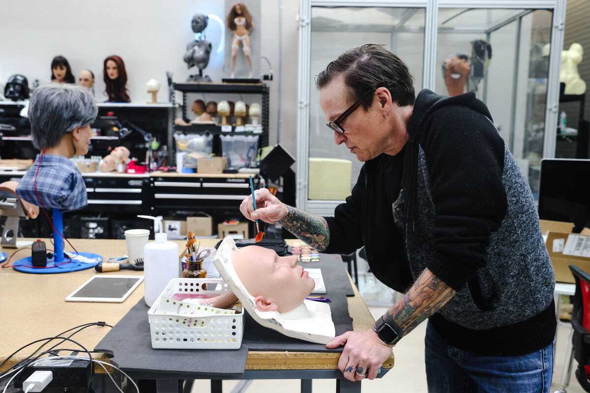 Founder Matt McMullen works on the face of a robot at the workshop for Realbotix, a company tha ...