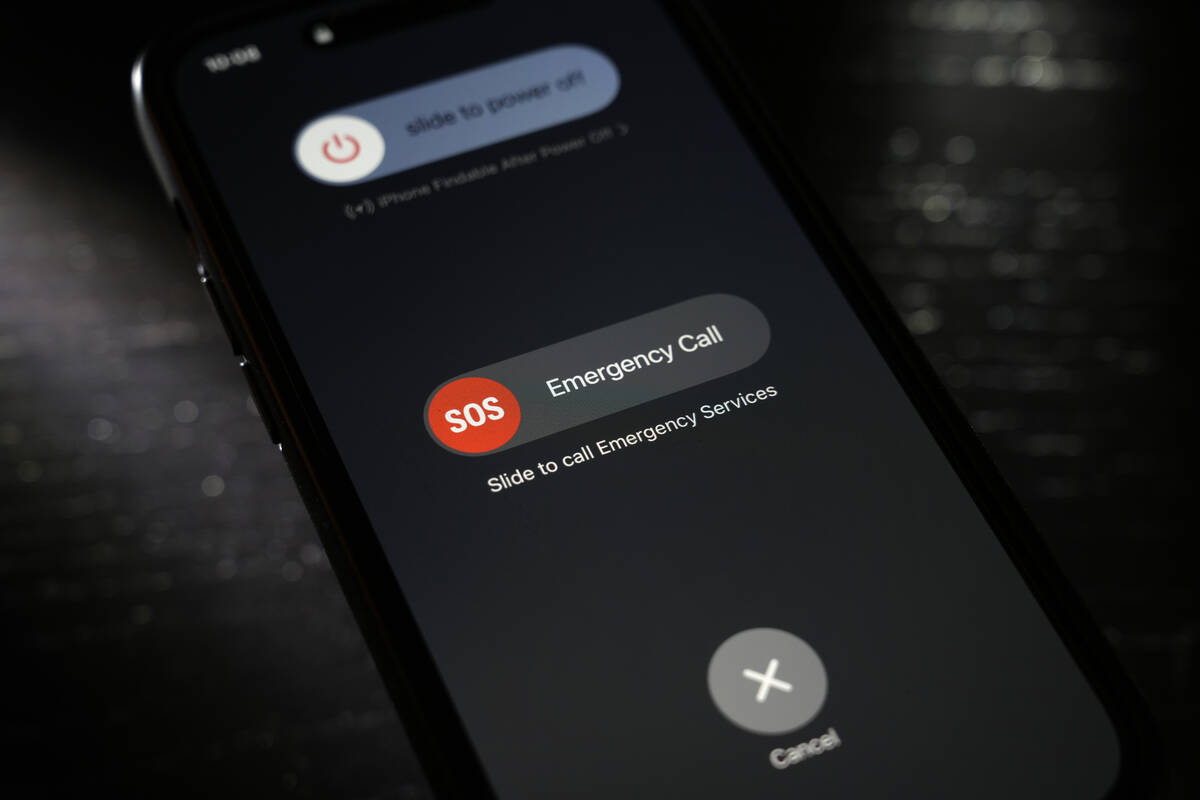 A button used to contact emergency services is seen on a mobile phone, Thursday, April 18, 2024 ...