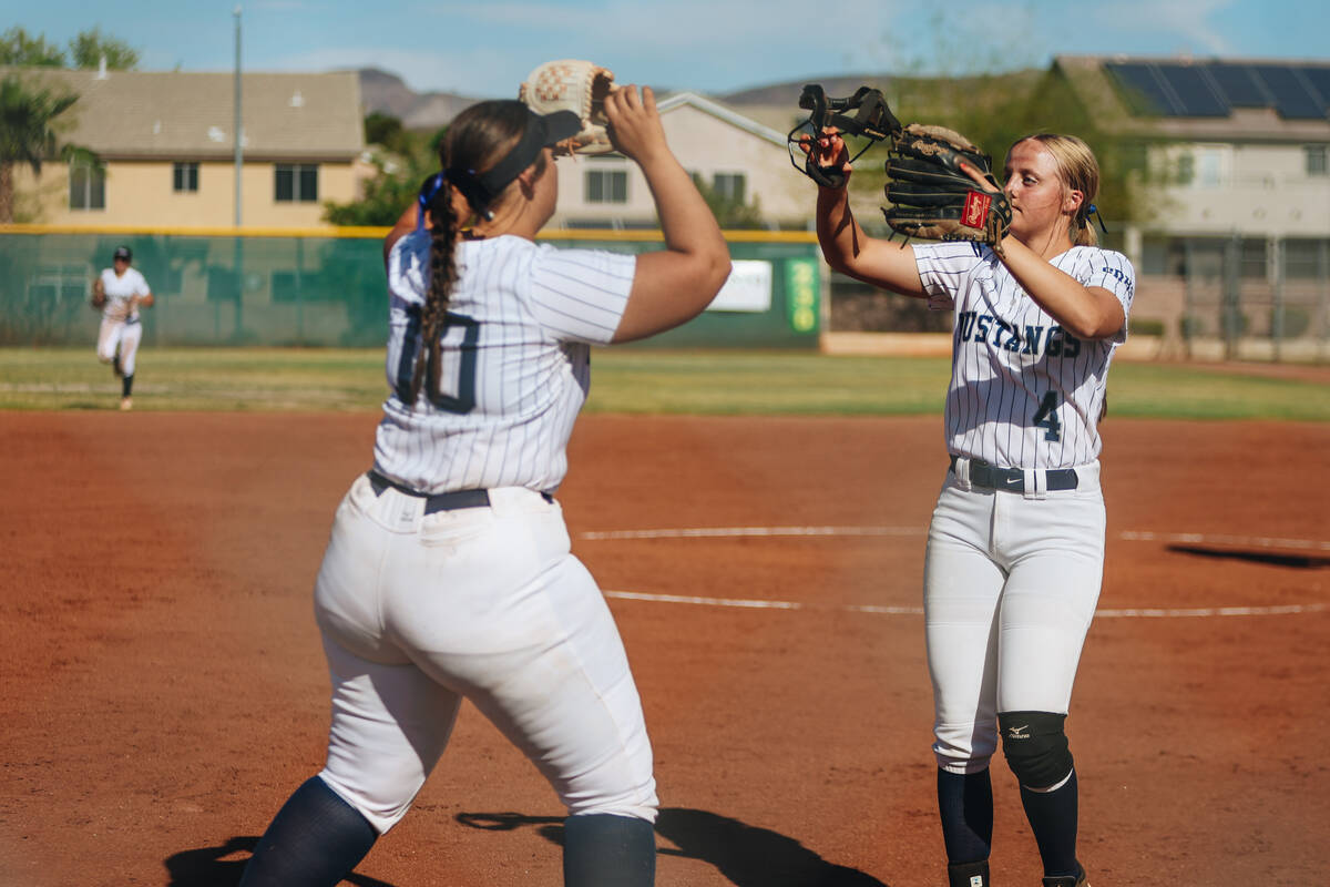 Shadow Ridge teammate Josslin Law (4) and Abby Covington (10) high-five during a softball game ...