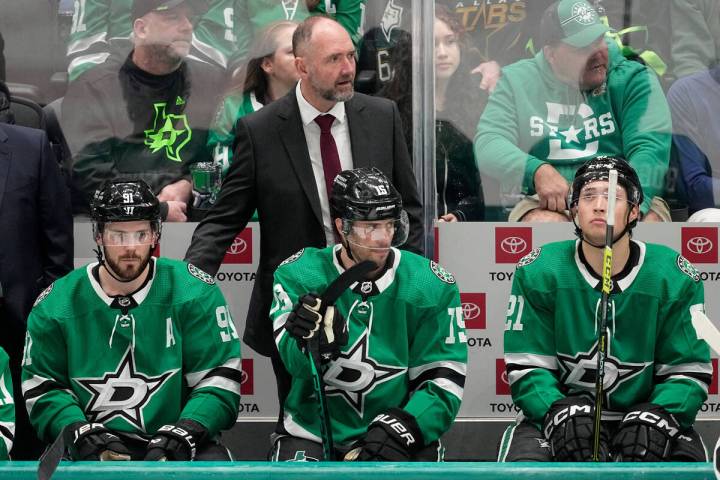 Dallas Stars' Tyler Seguin (91), Craig Smith (15), and Jason Robertson (21) sit on the bench in ...