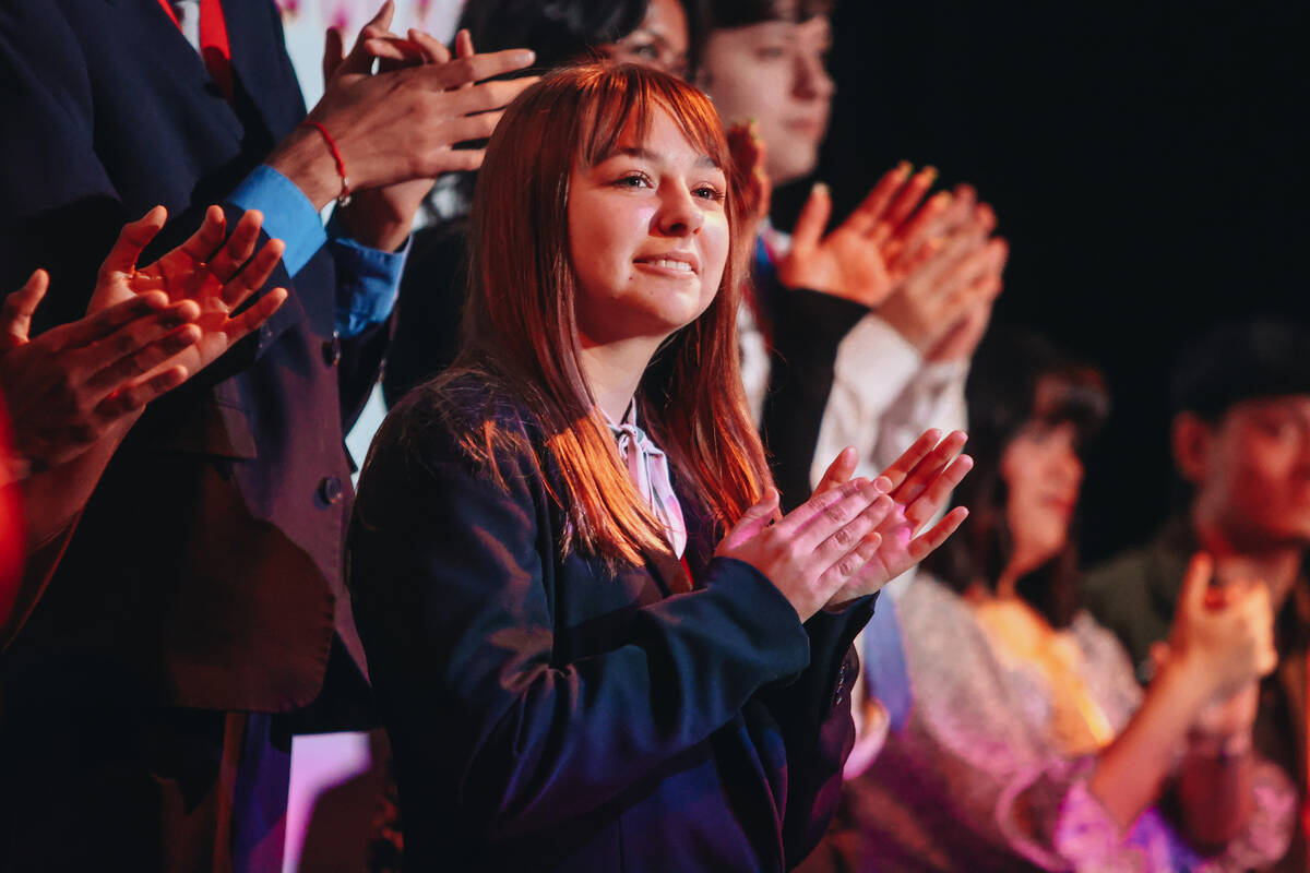 High school students clap as others receive college scholarships from The Rogers Foundation at ...