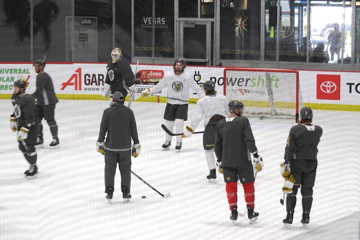 Golden Knights forward Mark Stone, center, participates in a practice session wearing a full co ...
