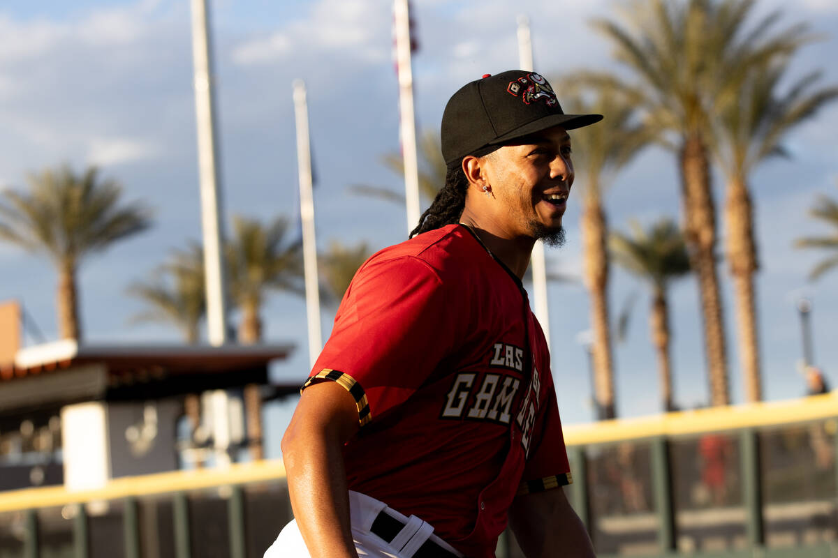 Las Vegas Aviators pitcher Osvaldo Bido, wearing a Las Vegas Gamblers jersey, warms up before a ...