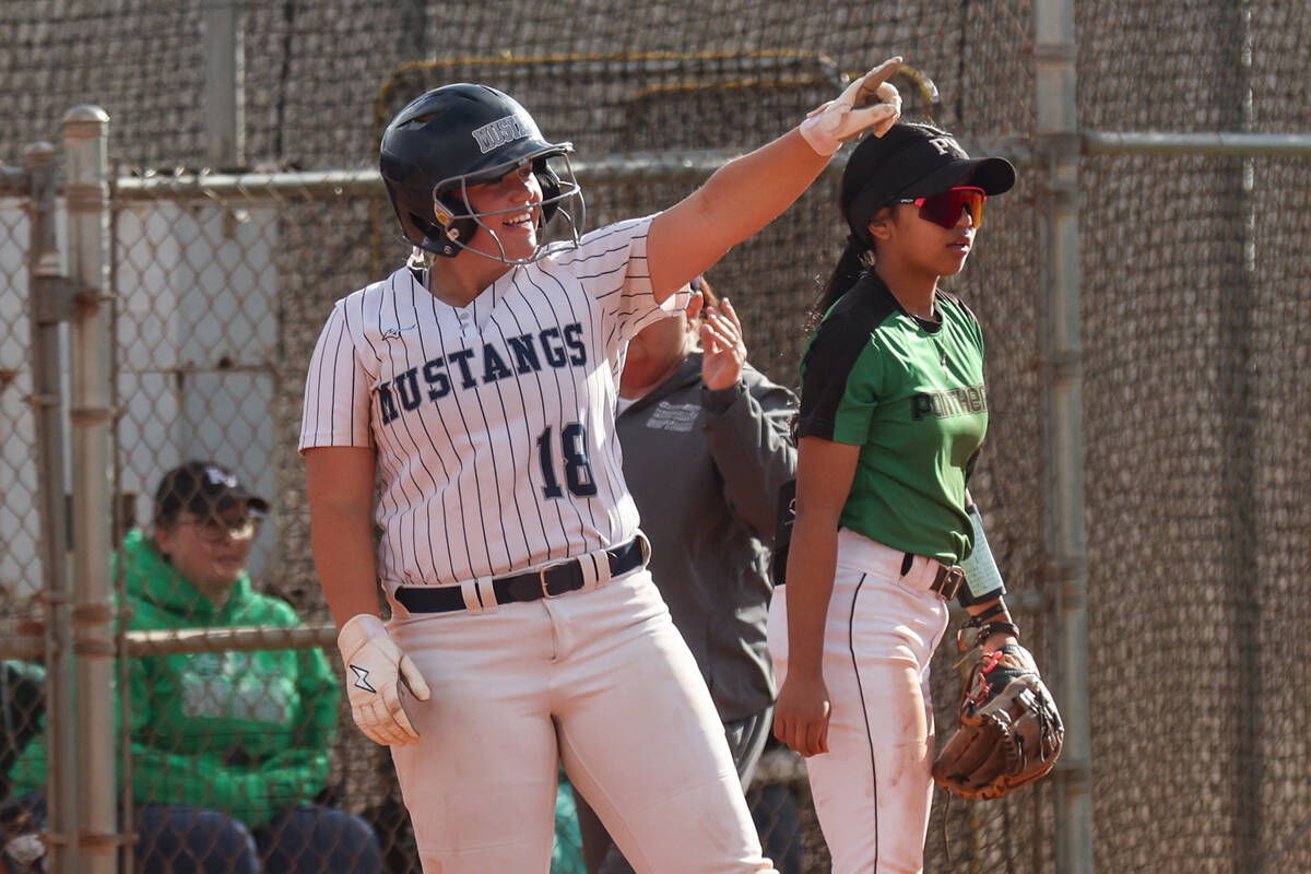 Shadow Ridge High School’s Madison Foster (18) gestures to her teammate after making it ...