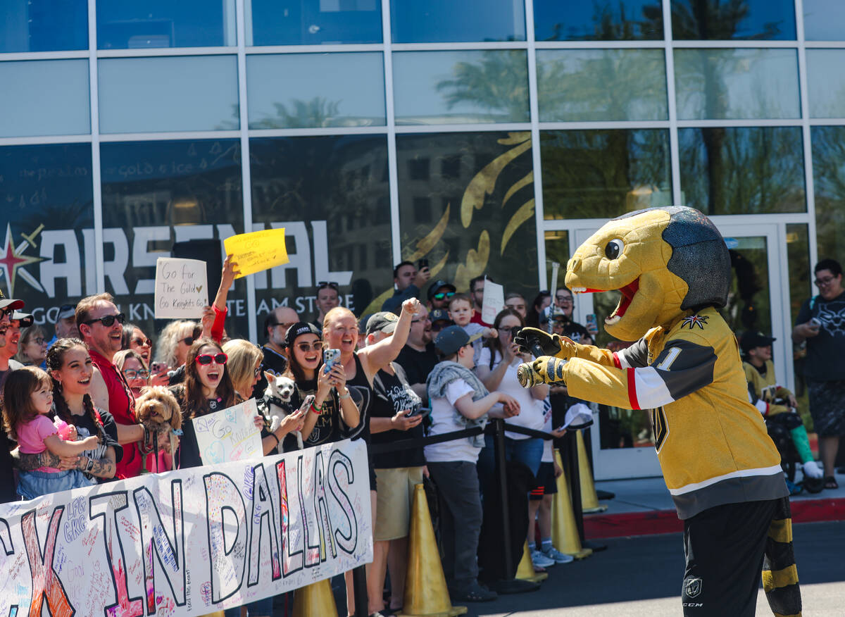 Golden Knights mascot Chance rallies the crowd as they wait for Golden Knights players to depar ...