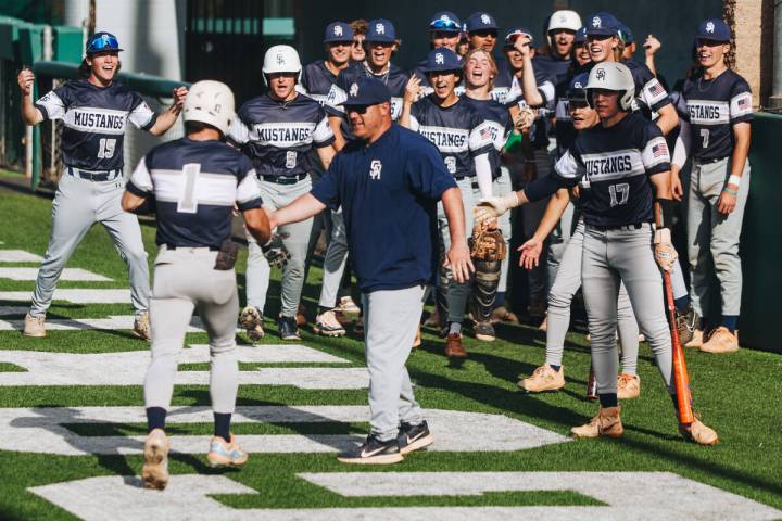 Shadow Ride players celebrate teammate Evan Noble (1) during an baseball game between Bishop Go ...