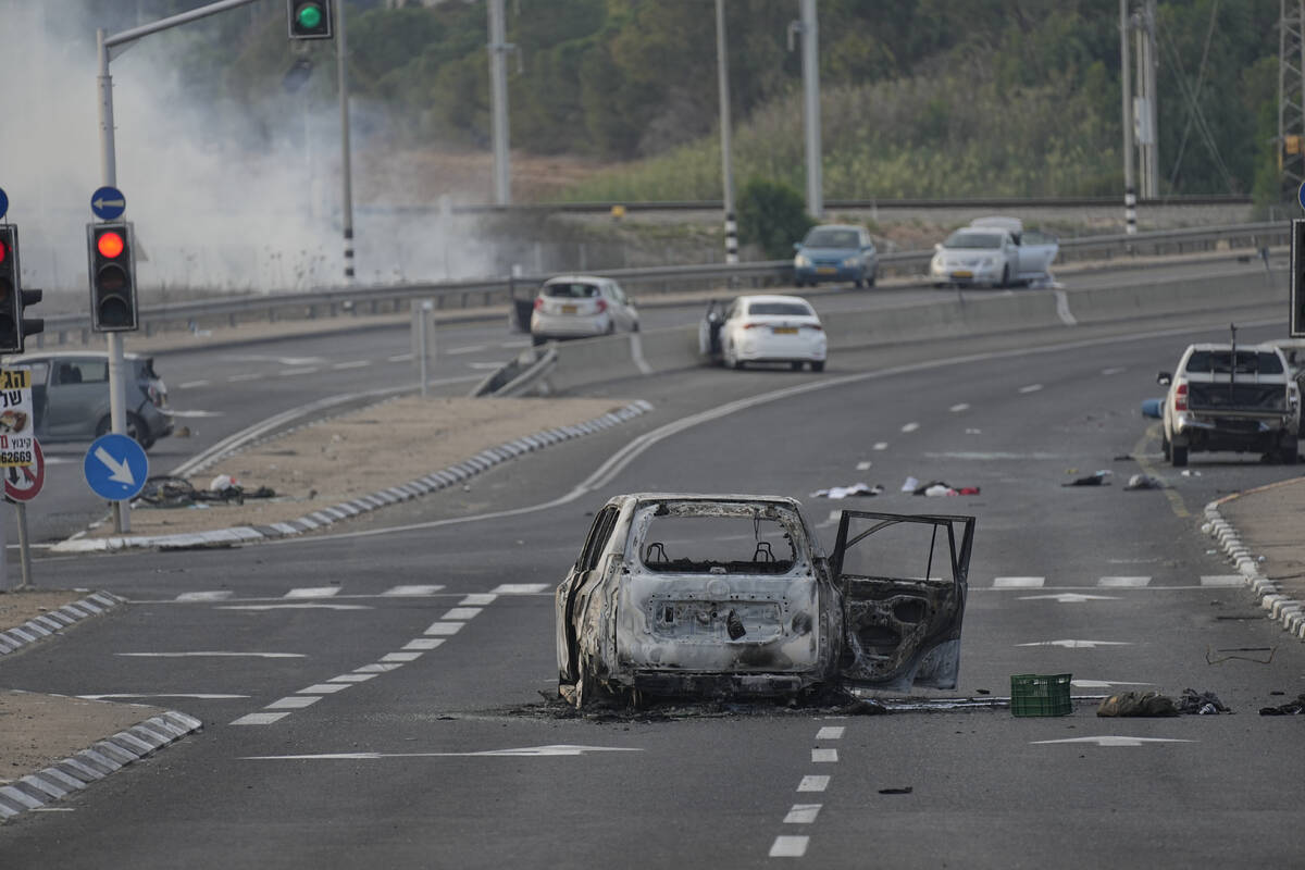 FILE - A car destroyed in an attack by Palestinian militants is seen in Sderot, Israel, on Satu ...