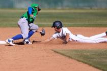 Green Valley infielder Caden Kirby (12) tags out Foothill baserunner Makoa Elliott (18) in the ...