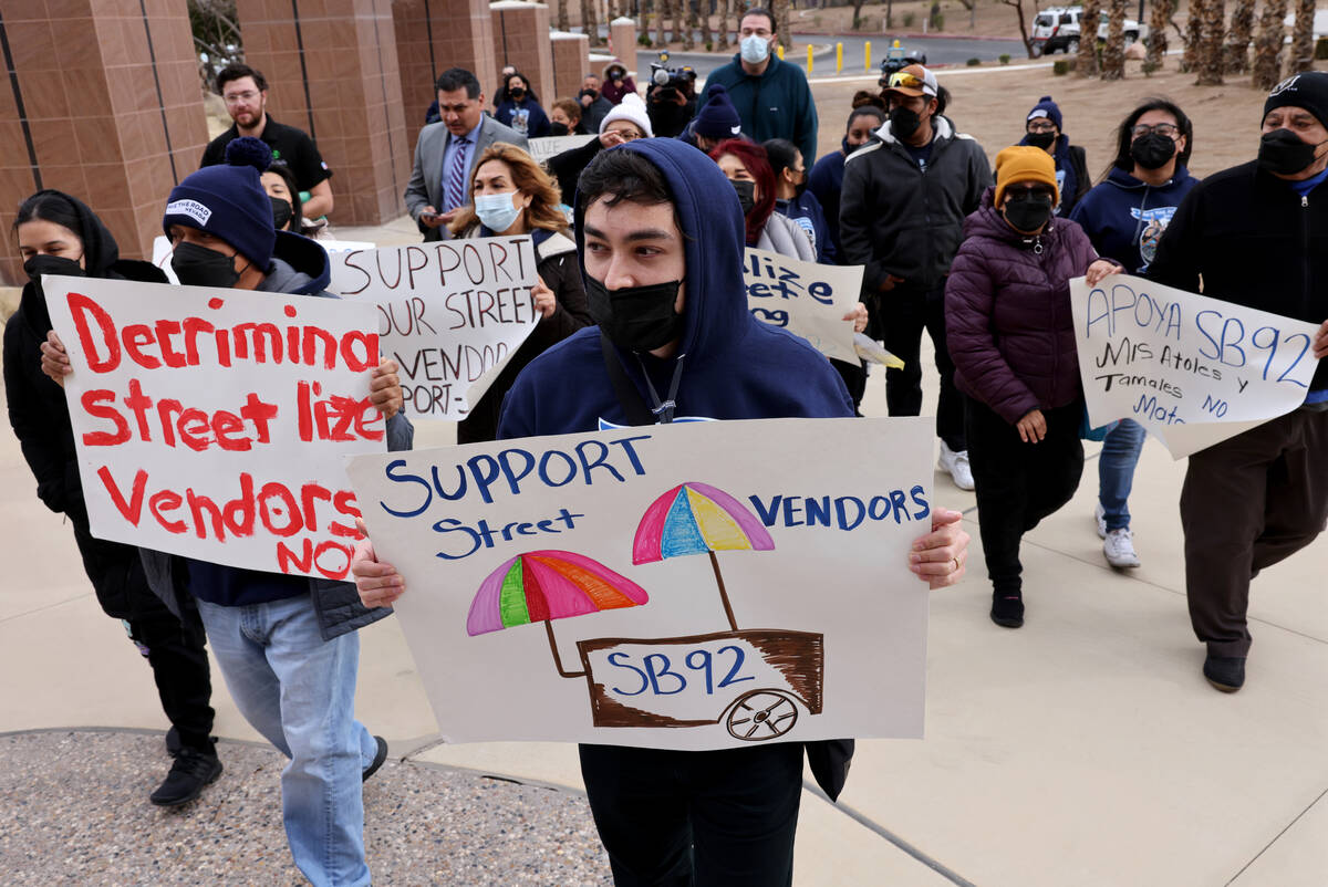 People with Make the Road Nevada, including Jacob Egan 26, front, gather at the Sawyer Building ...