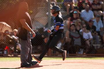 Basic outfielder Troy Southisene (2) celebrates as he scores at home plate during a high school ...