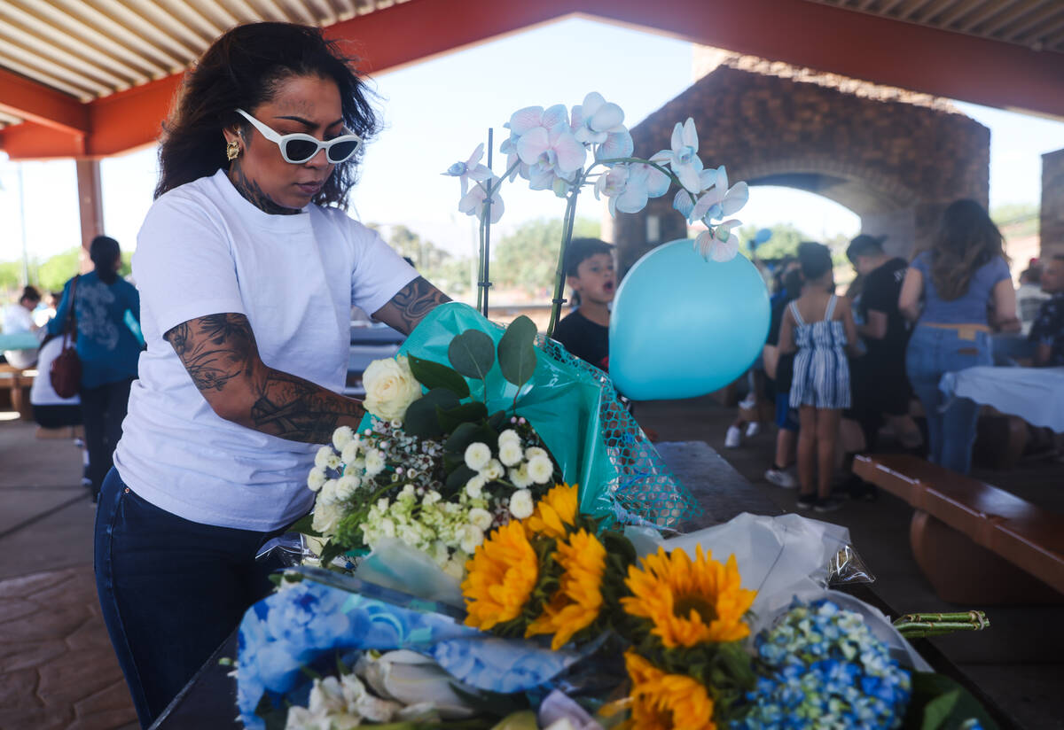 Sydney Read, friend of Tabatha Tozzi, adjusts flowers set out at a celebration of Tozzi’ ...