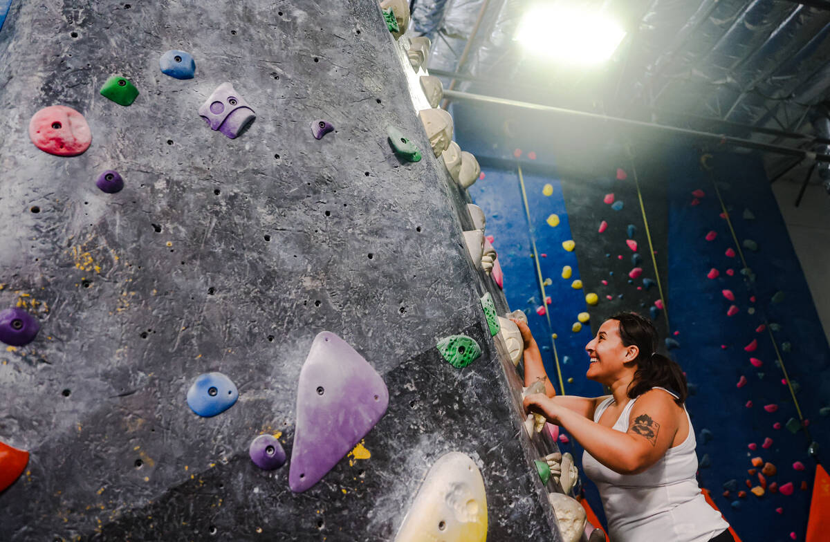 Andrea Villanueva free climbs a rock wall following a panel about outdoor recreational access, ...