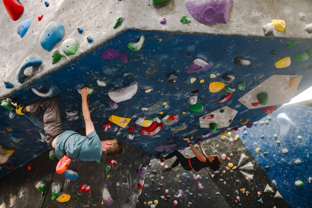 Jay McCandless, left, and his wife Marijke McCandless, right, free climb a rock wall following ...