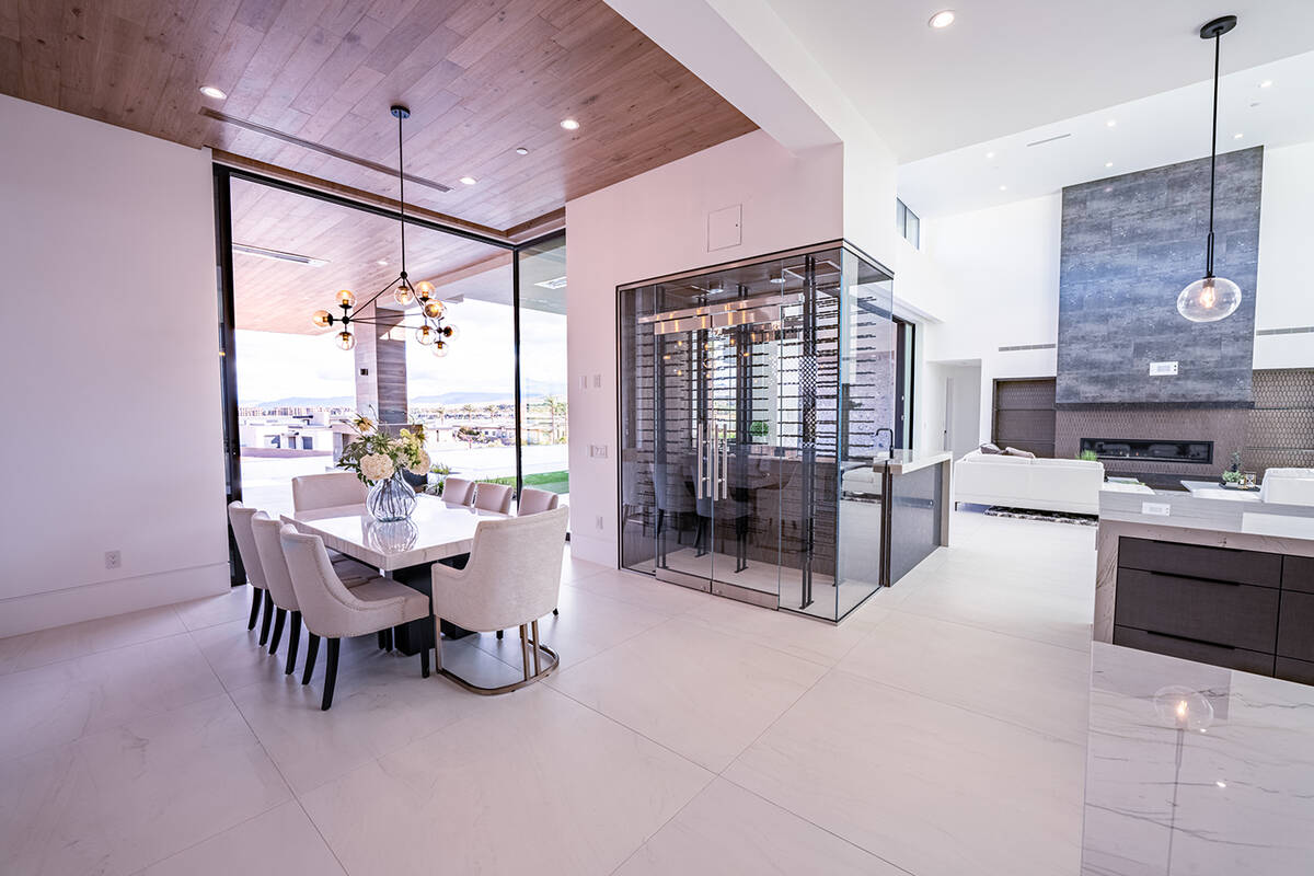 Between the formal dining and living spaces is a unique glass-encased, temperature-controlled w ...
