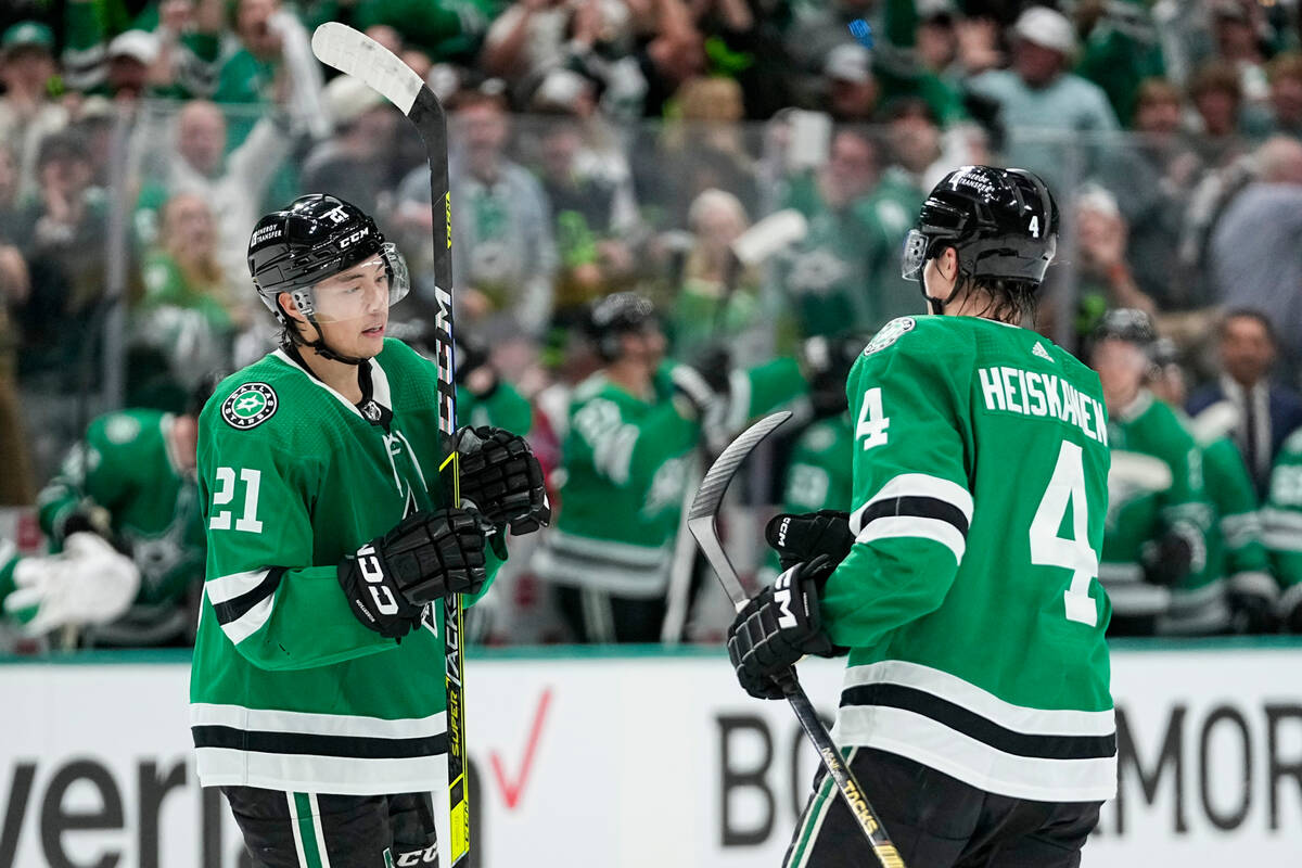 Dallas Stars left wing Jason Robertson (21) celebrates his first period goal with Miro Heiskane ...