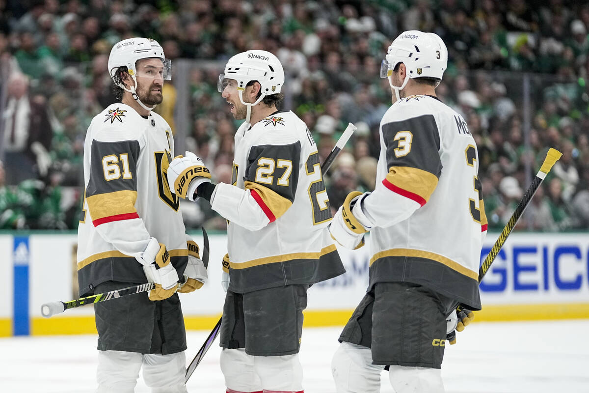 Vegas Golden Knights' Mark Stone (61), Shea Theodore (27) and Brayden McNabb (3) gather during ...