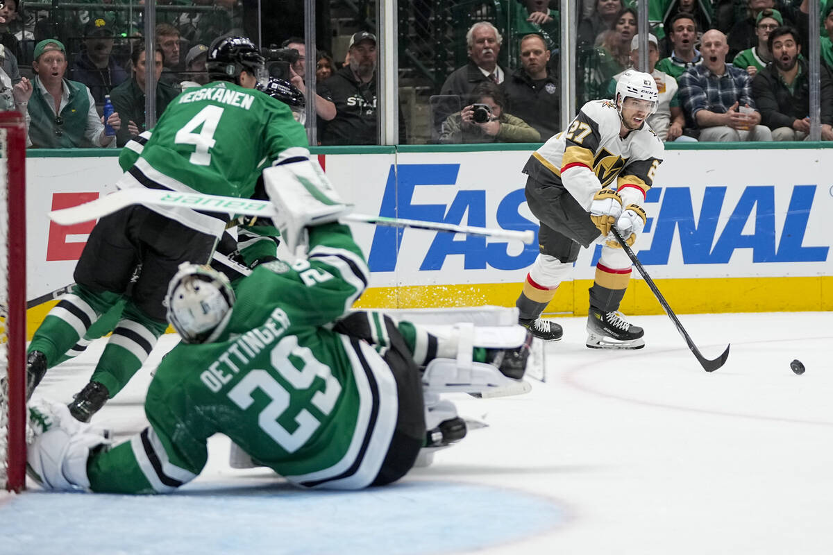 Vegas Golden Knights defenseman Shea Theodore (27) passes the ball as Dallas Stars goaltender J ...