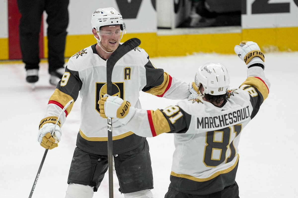 Vegas Golden Knights center Jack Eichel, left, celebrates his empty net goal with Jonathan Marc ...