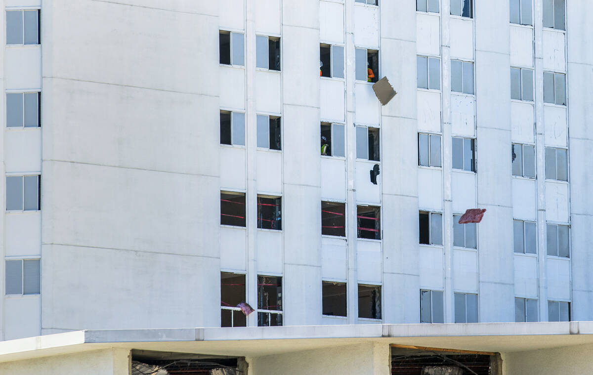 Demolition work continues on the Tropicana as worked toss interior wall pieces out the windows ...