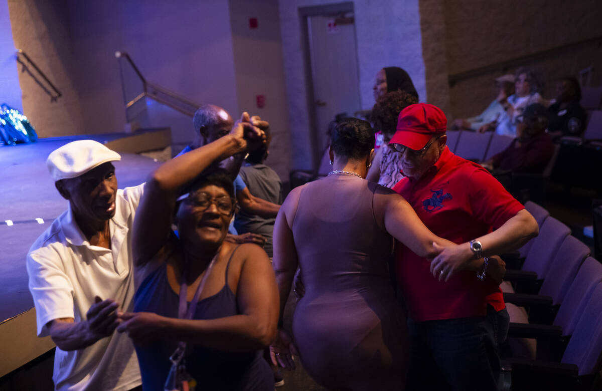 Attendees dance as Vegas Groove & The Silver State Horns perform during an event celebratin ...