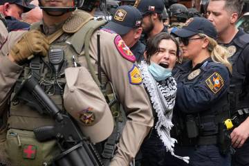 A woman is arrested at a pro-Palestinian protest at the University of Texas, Wednesday, April 2 ...