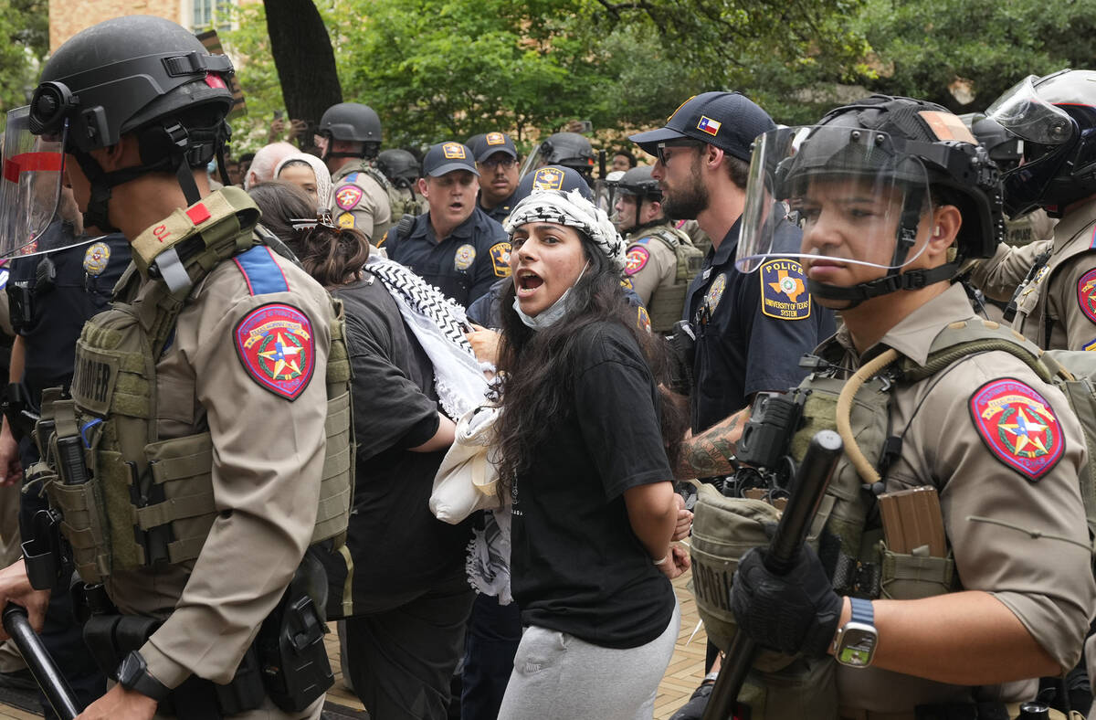 A woman is arrested at a pro-Palestinian protest at the University of Texas, Wednesday April 24 ...