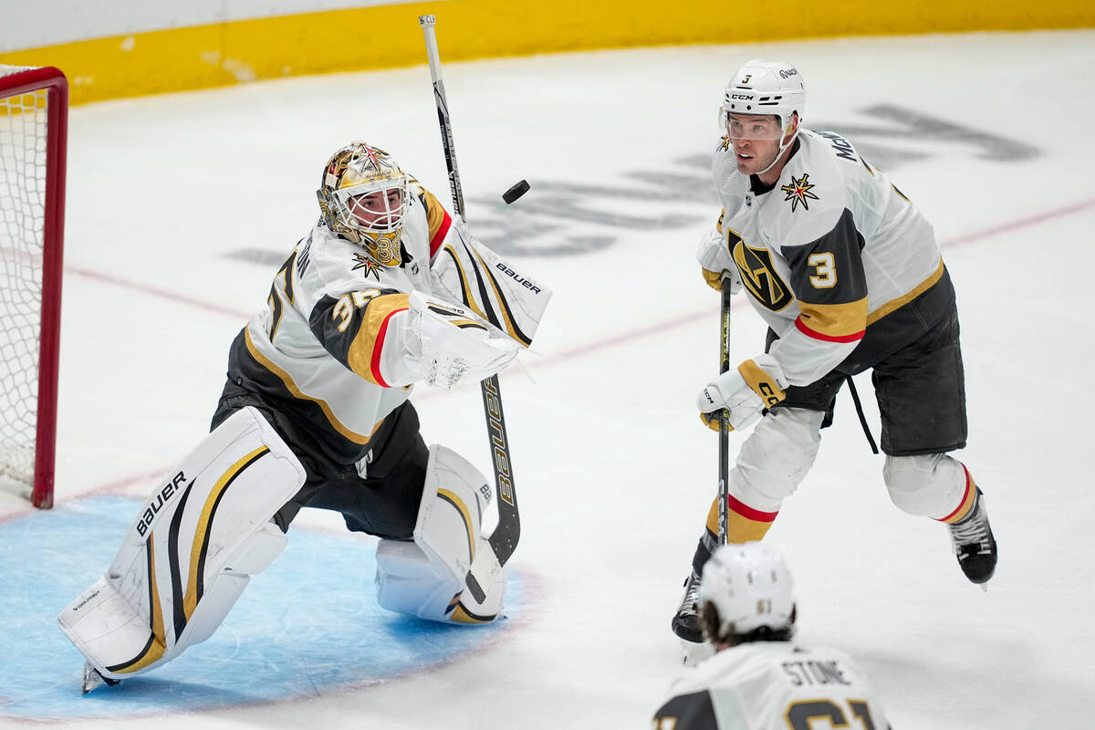 Vegas Golden Knights goaltender Logan Thompson, left, and defenseman Brayden McNabb (3) eye the ...