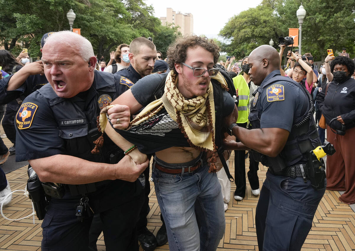 University of Texas police officers arrest a man at a pro-Palestinian protest on campus, Wednes ...