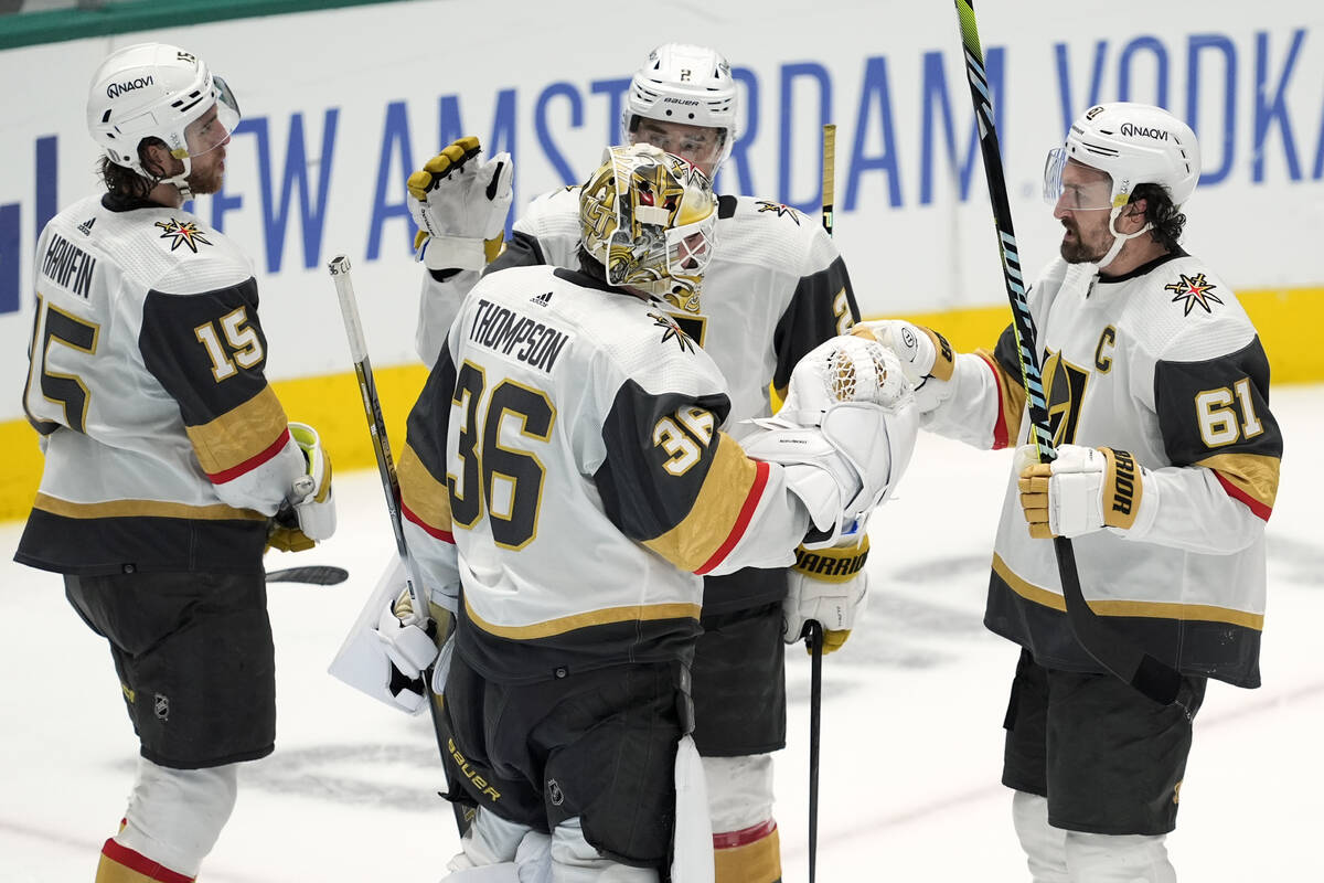 Vegas Golden Knights goaltender Logan Thompson (36) celebrates with Mark Stone (61), Noah Hanif ...