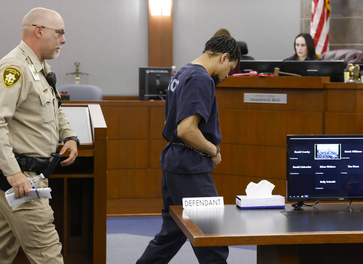 Terrell Rhodes is escorted out of the courtroom as District Court judge Jacqueline Bluth, right ...