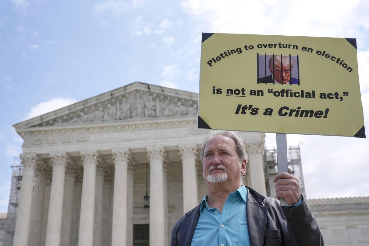 A demonstrator stands outside the Supreme Court as the justices prepare to hear arguments over ...