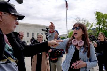 Demonstrators protest outside the Supreme Court as the justices prepare to hear arguments over ...