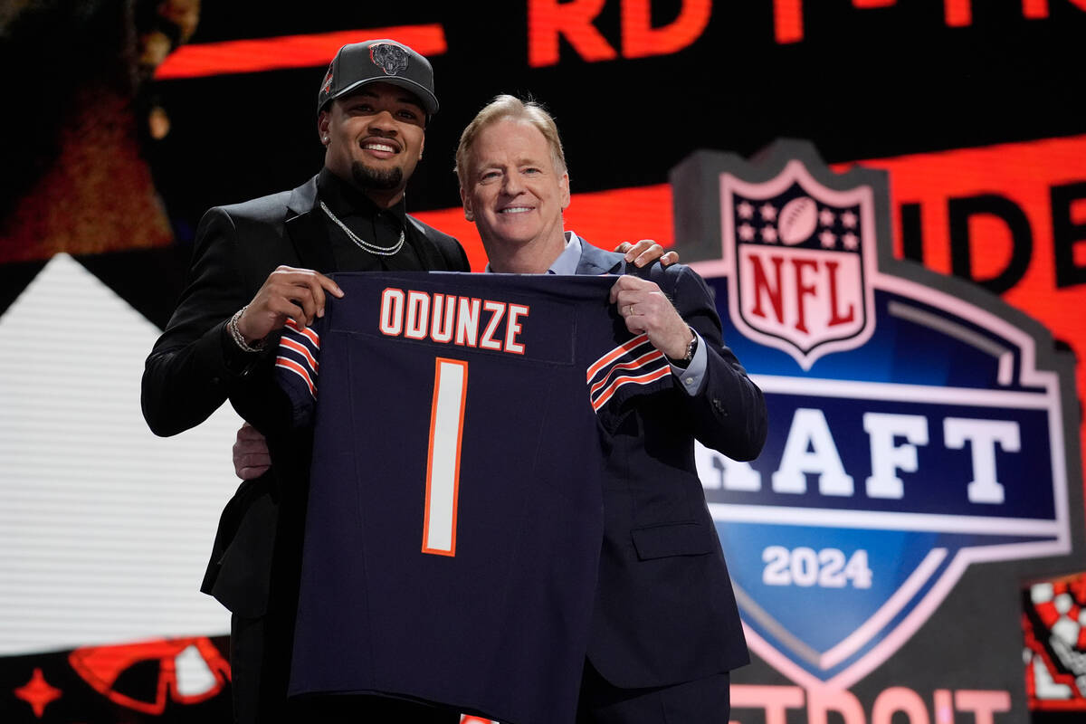 Washington wide receiver Rome Odunze, left, poses with NFL Commissioner Roger Goodell after bei ...