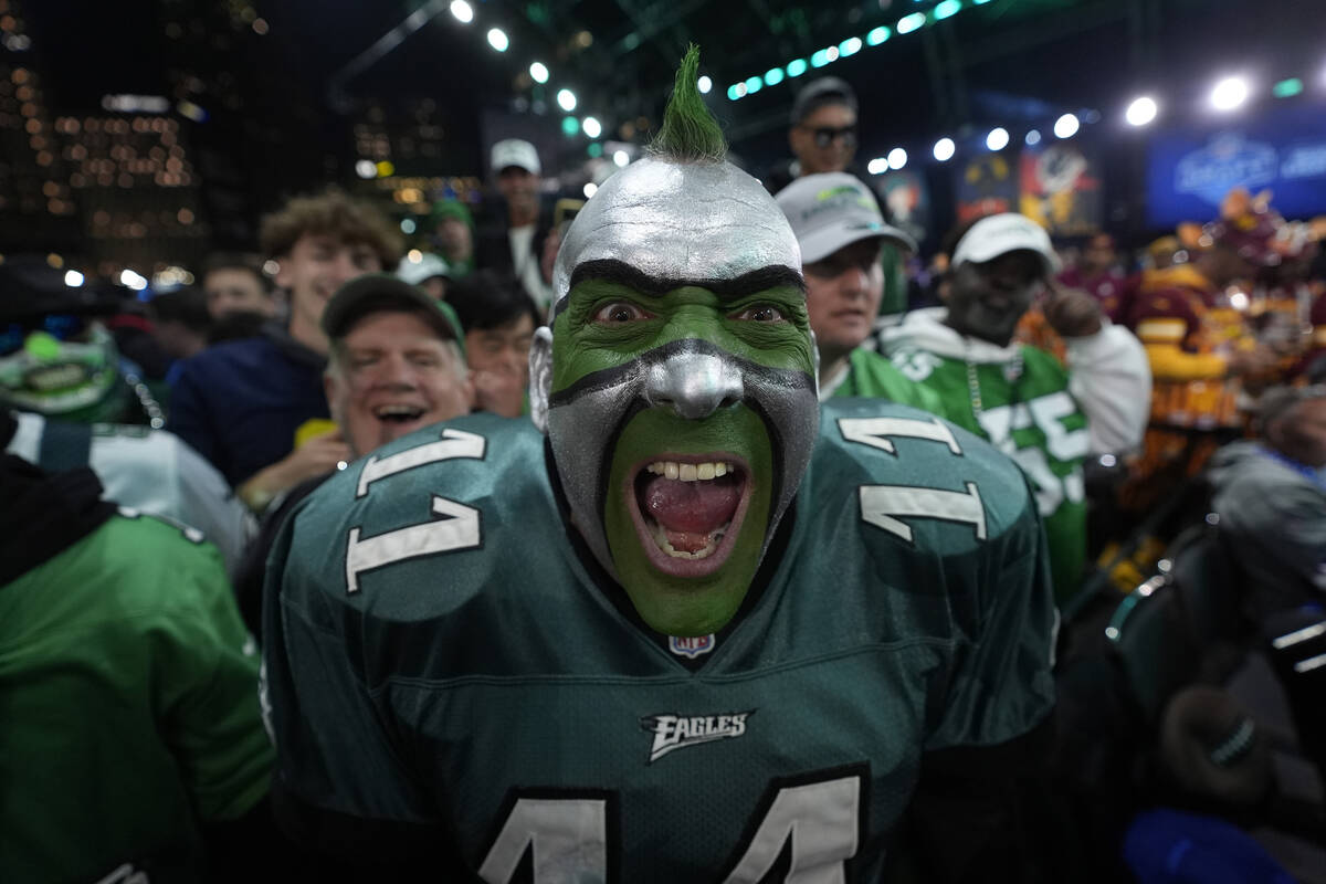 A Philadelphia Eagles fan cheers during the first round of the NFL football draft, Thursday, Ap ...