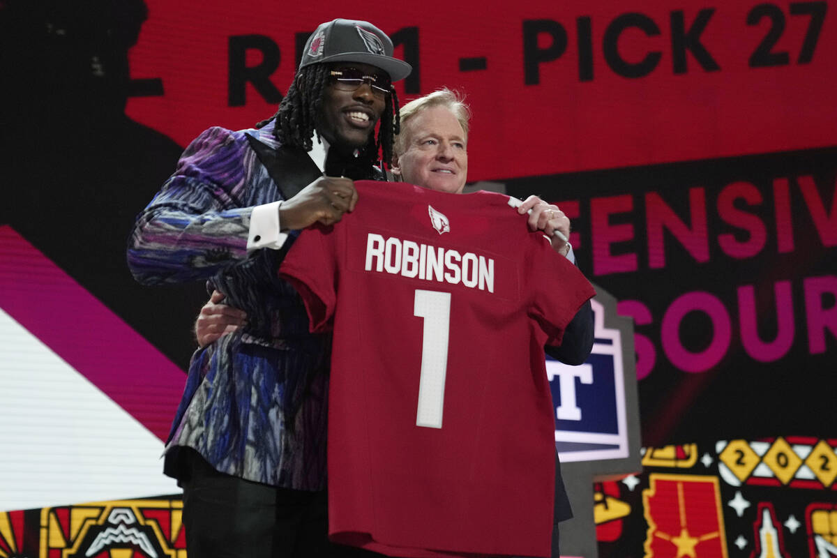 Missouri defensive lineman Darius Robinson, left, poses with NFL Commissioner Roger Goodell aft ...