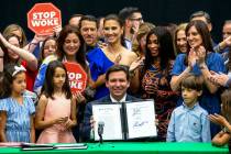 FILE - Florida Gov. Ron DeSantis smiles after publicly signing HB7, "individual freedom," also ...