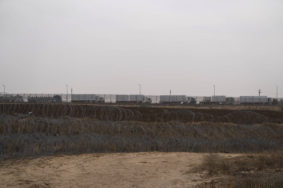 Trucks, carrying humanitarian supplies for the Gaza Strip, wait in line on the Egyptian side, a ...