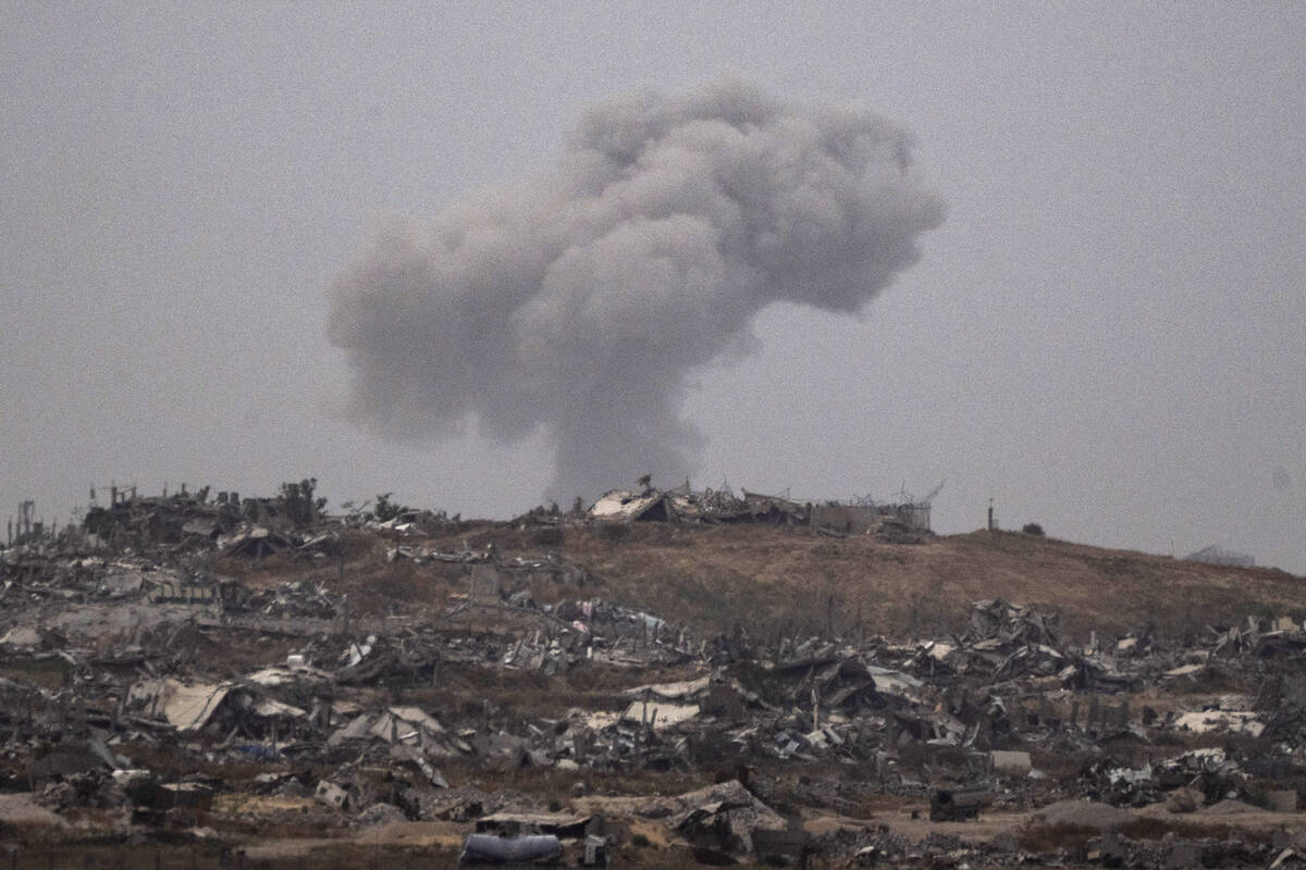 Smoke rises to the sky after an explosion in the Gaza Strip as seen from southern Israel, Thurs ...