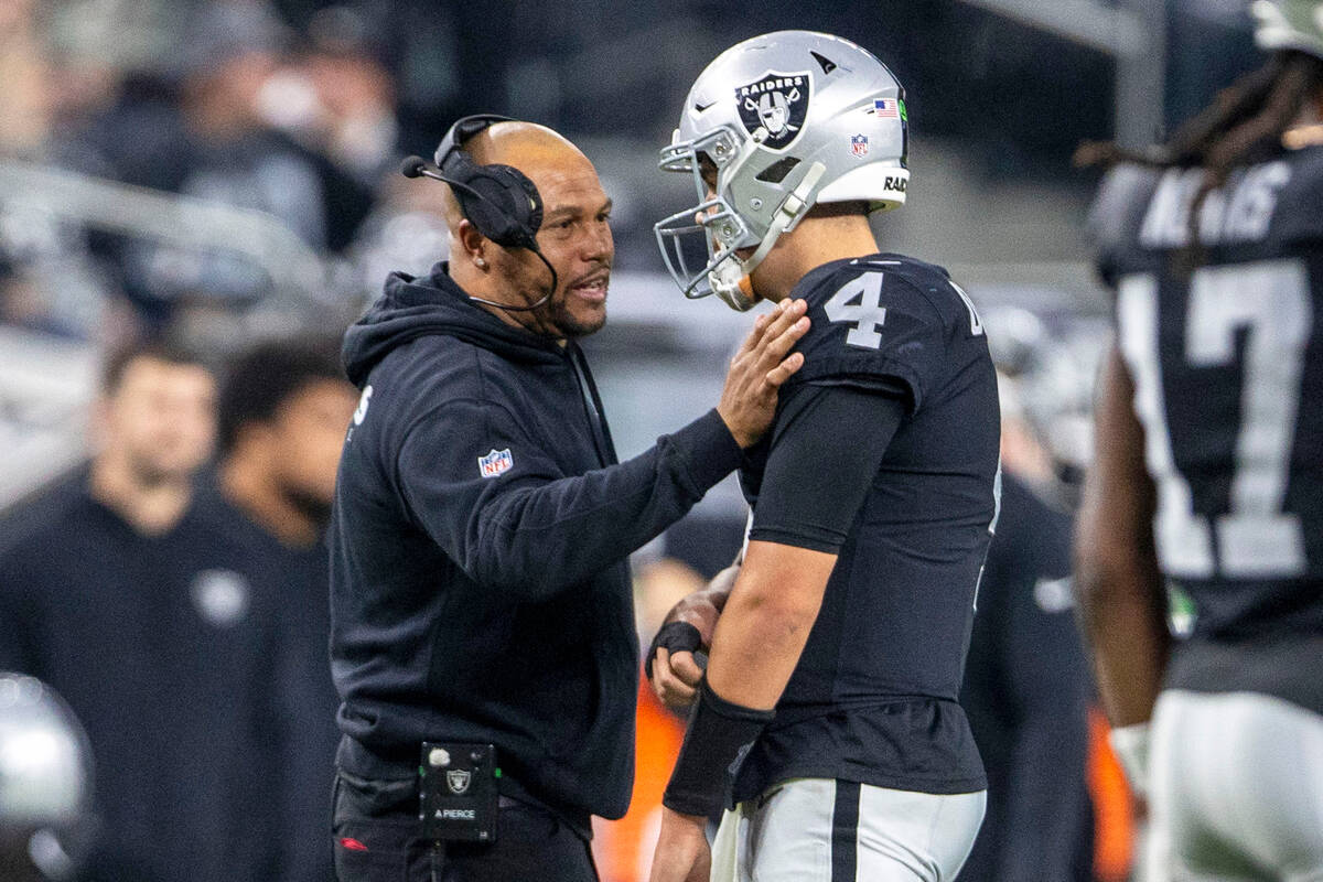 Raiders interim head coach speaks with quarterback Aidan O'Connell (4) during a time out during ...