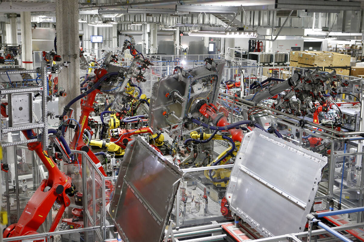 Robots work in many areas of the Tesla Gigafactory, east of Reno, Nev., on Tuesday, Dec. 4, 201 ...