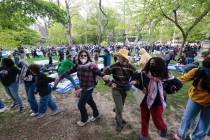 People lock arms during a Pro-Palestinian protest on Penn's campus in Philadelphia on Thursday, ...