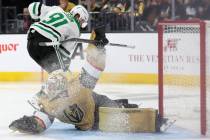 Golden Knights goaltender Logan Thompson (36) saves the puck while Stars center Tyler Seguin (9 ...