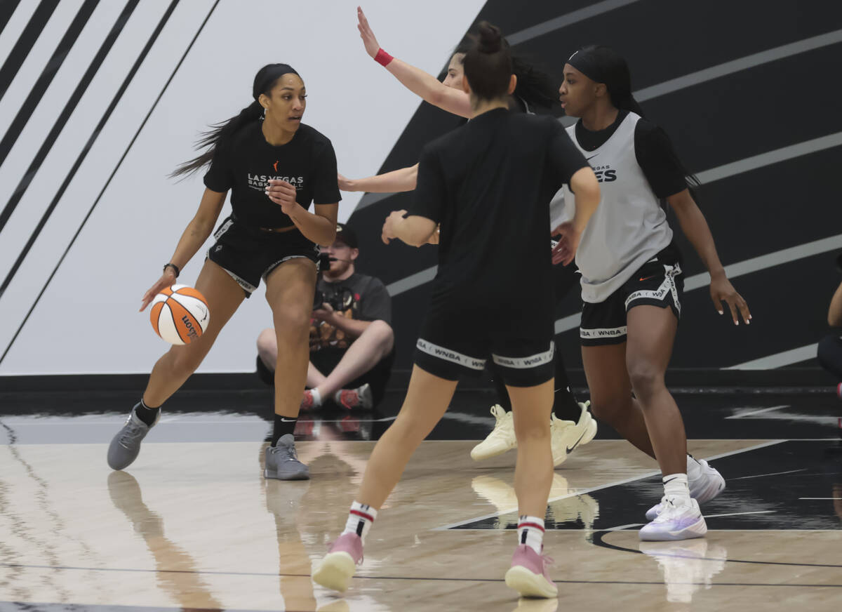 Las Vegas Aces forward A'ja Wilson, left, drives the ball during practice at the team’s ...