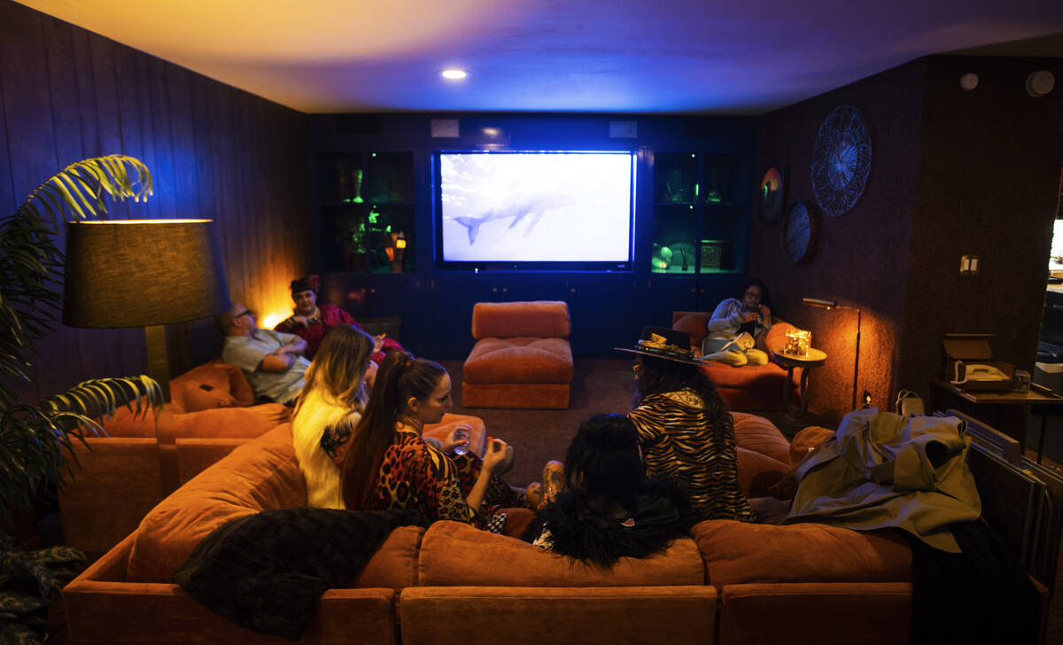 Attendees relax during an evening party at a Beverly Green home called “Lava Houseȁ ...