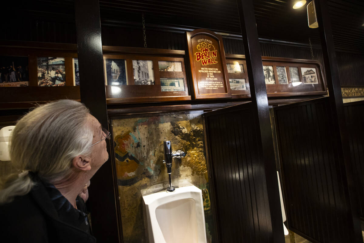 A piece of the Berlin Wall is seen in a men’s restroom at Main Street Station during a t ...