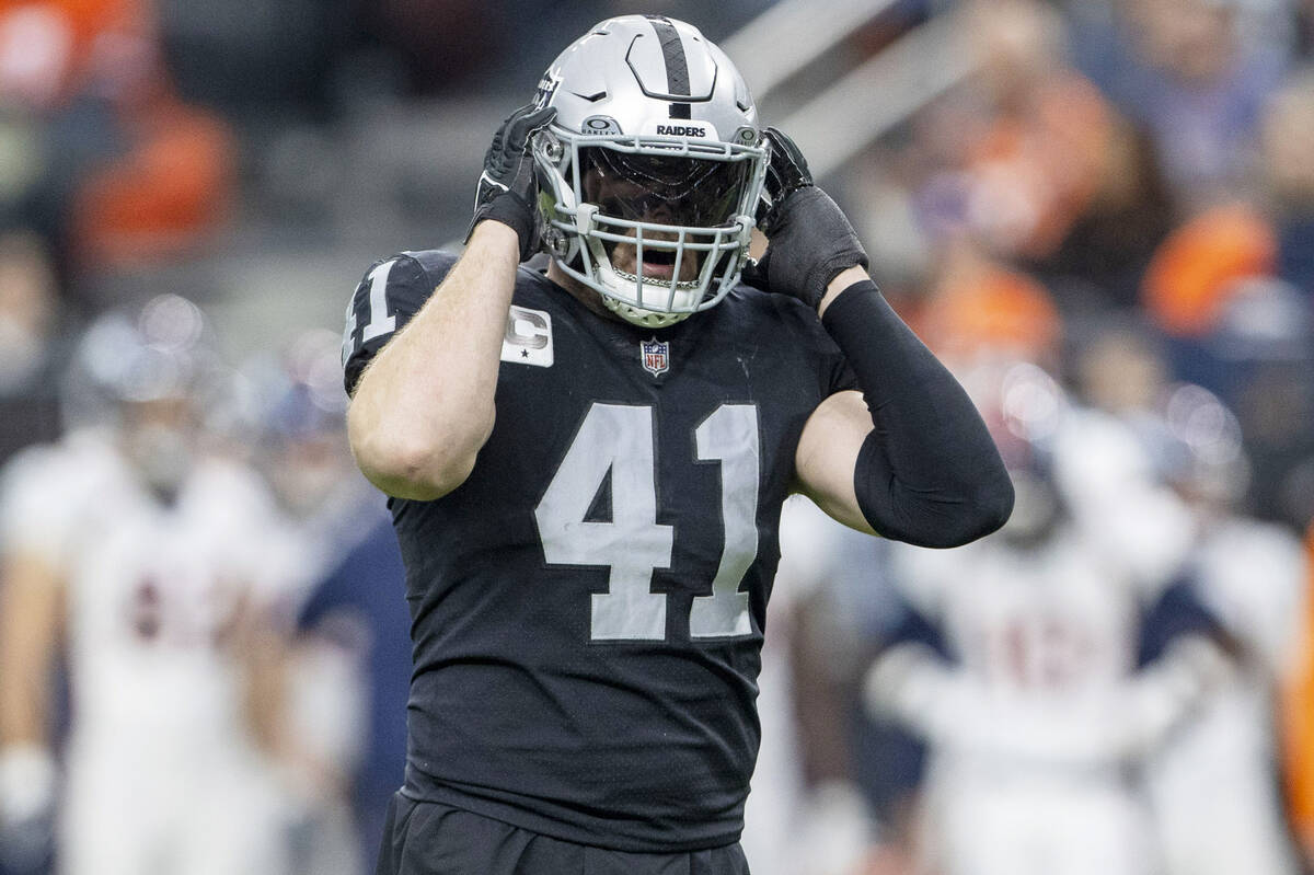 Raiders linebacker Robert Spillane (41) adjusts his helmet during the first half of an NFL game ...