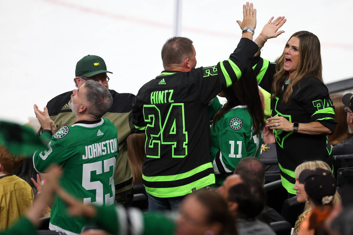 Stars fans celebrate after their team scored during the first period in Game 4 of an NHL hockey ...