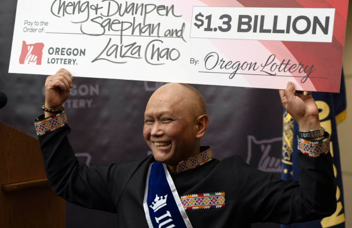 Cheng "Charlie" Saephan holds a display check during a news conference at the Oregon Lottery he ...